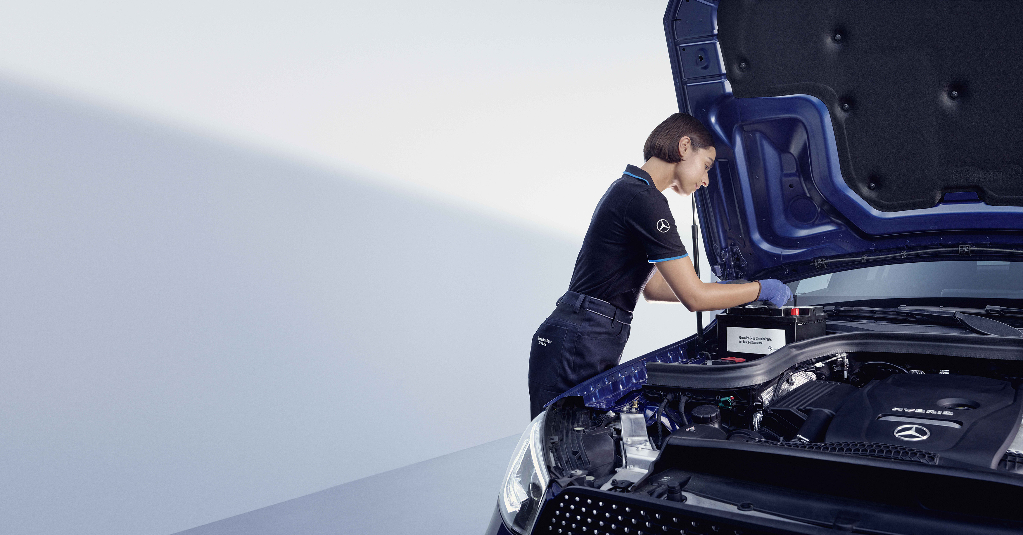 Reparo da Mercedes-Benz Um técnico da Mercedes-Benz verifica a bateria.