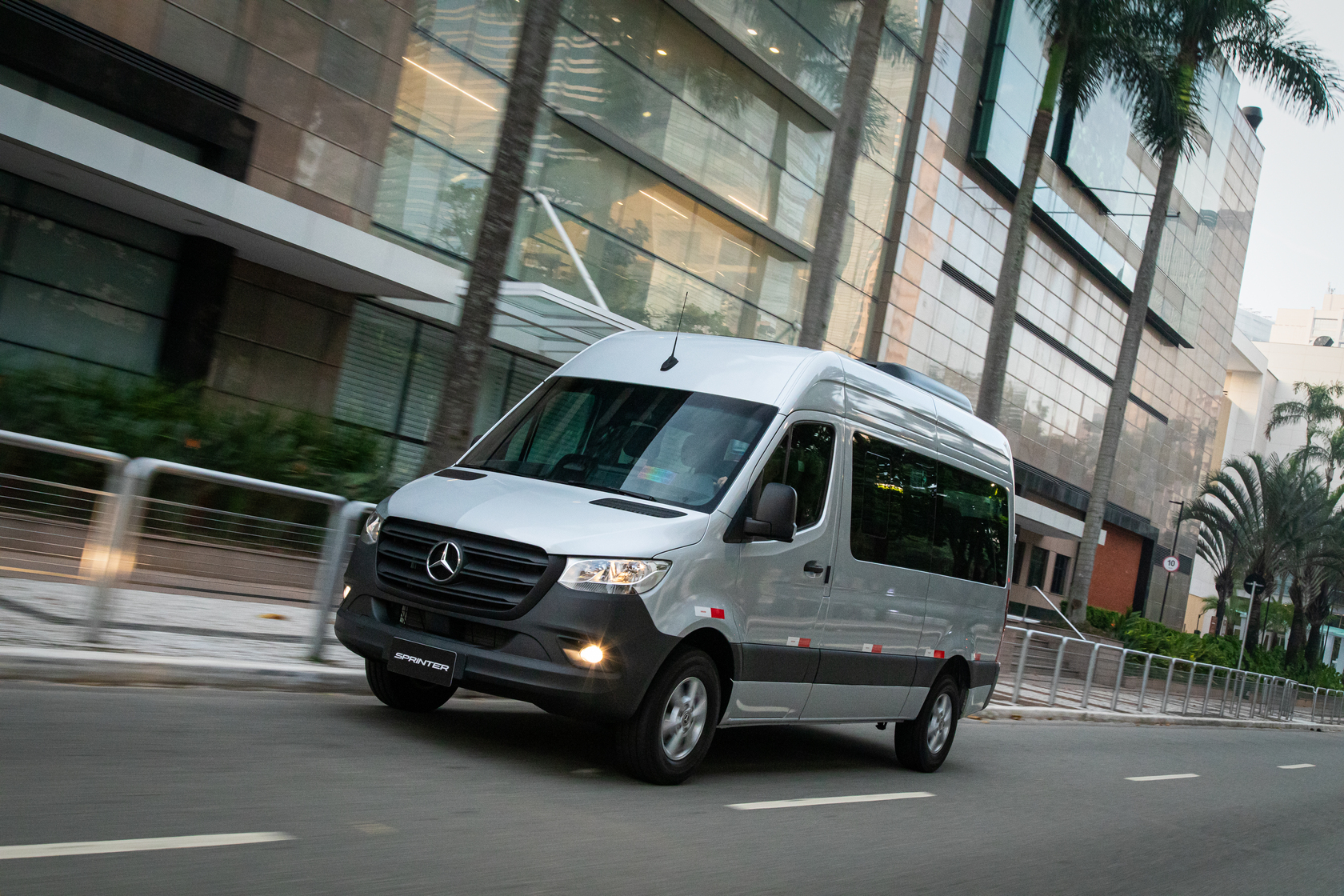 Sprinter Van Passageiro | Câmbio Automático | Mercedes-Benz Vans Uma Sprinter Van Passageiro com câmbio automático em uma rua.