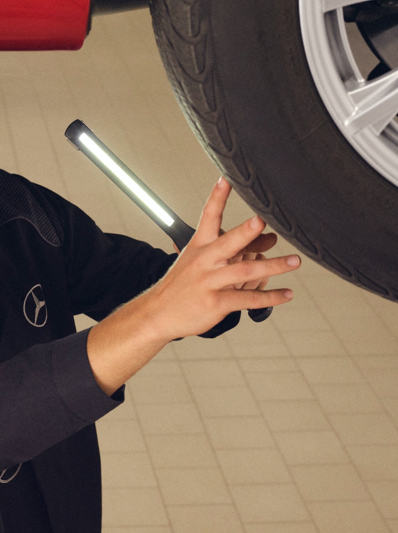 Um mecânico da Mercedes-Benz realiza uma troca do pneu.